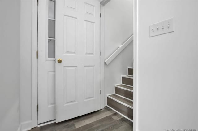 staircase with hardwood / wood-style flooring