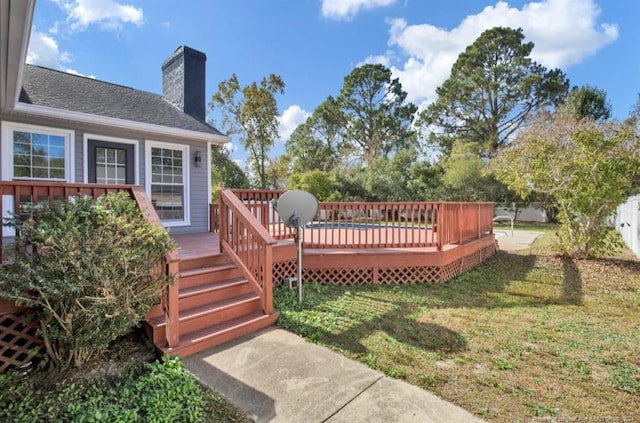 wooden deck with a lawn