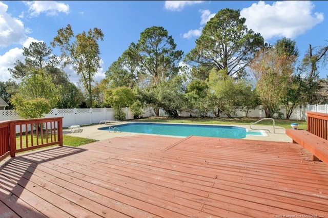 view of swimming pool with a deck and a diving board