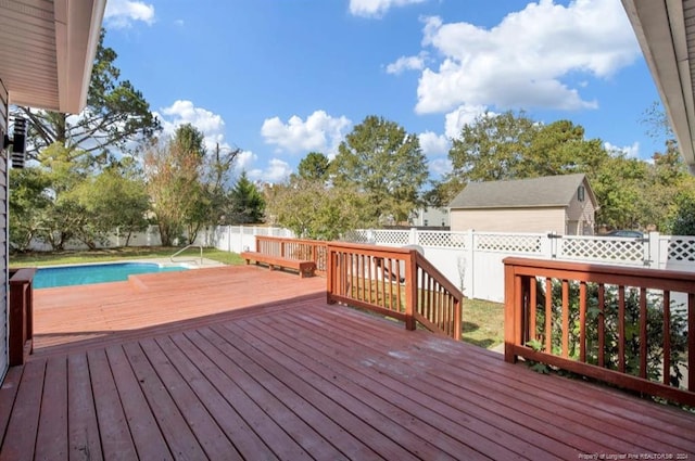 deck featuring a fenced in pool