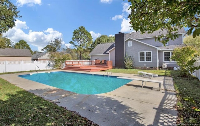 view of swimming pool with a deck, a diving board, and a patio area