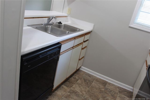 kitchen with white cabinets, black dishwasher, and sink