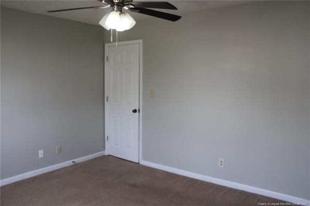 carpeted spare room featuring ceiling fan