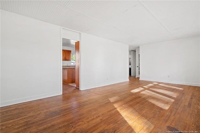 empty room with hardwood / wood-style flooring