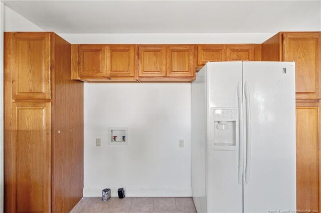 laundry room featuring light tile patterned floors and hookup for a washing machine