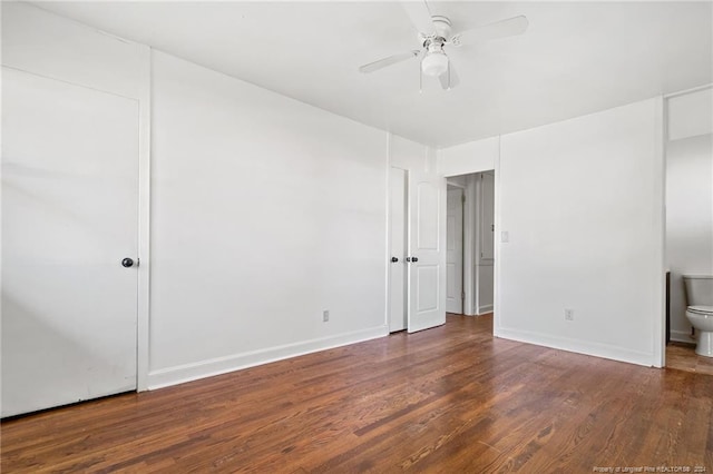 empty room with ceiling fan and dark wood-type flooring