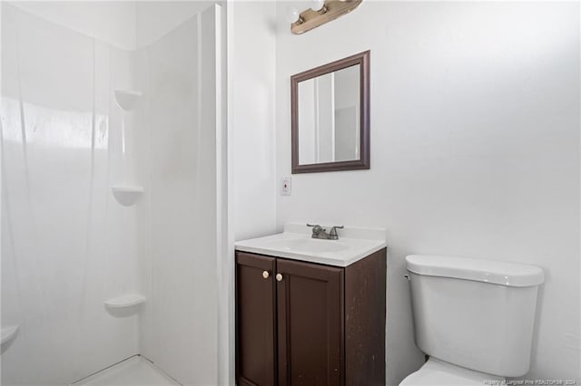 bathroom with vanity, toilet, and walk in shower