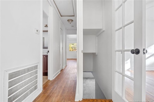 corridor with wood-type flooring