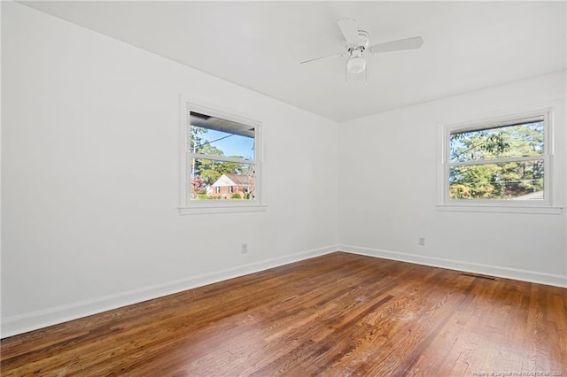 unfurnished room with hardwood / wood-style floors and ceiling fan