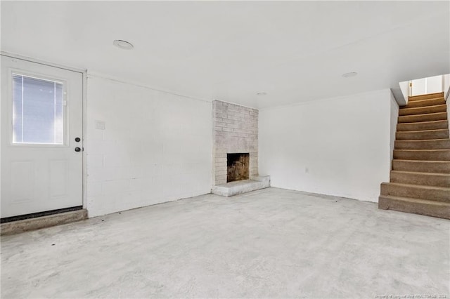 unfurnished living room featuring a brick fireplace