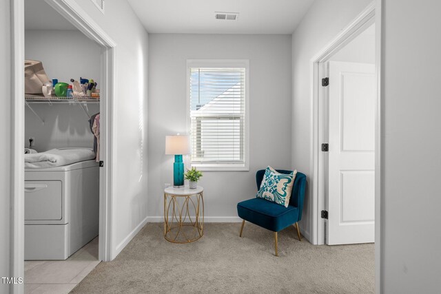 living area featuring washer / dryer and light colored carpet