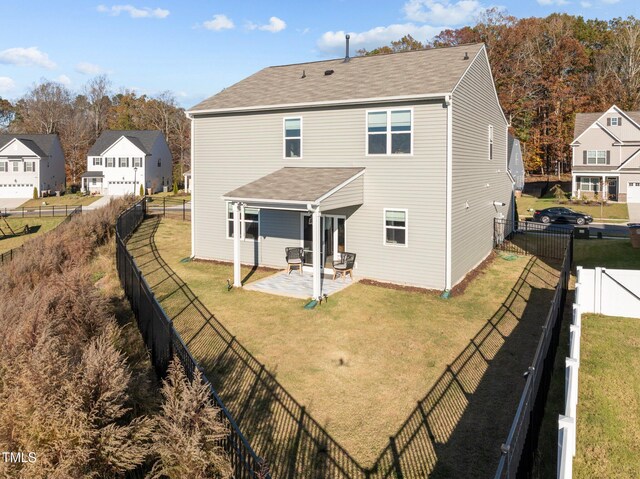 back of property featuring a yard and a patio