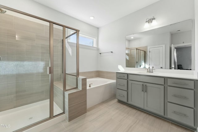 bathroom with vanity and independent shower and bath