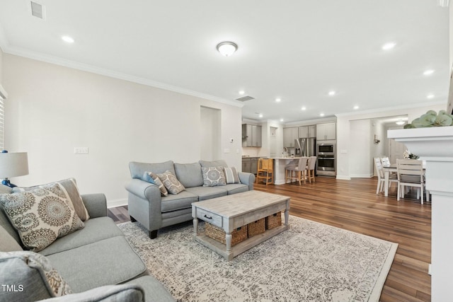 living room with hardwood / wood-style flooring and ornamental molding