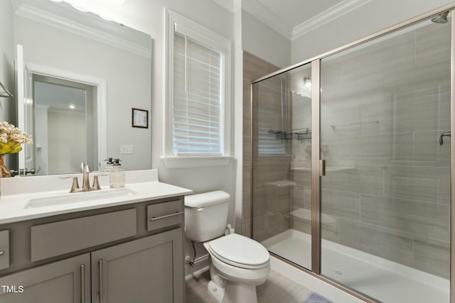 bathroom featuring a shower with shower door, toilet, ornamental molding, and vanity