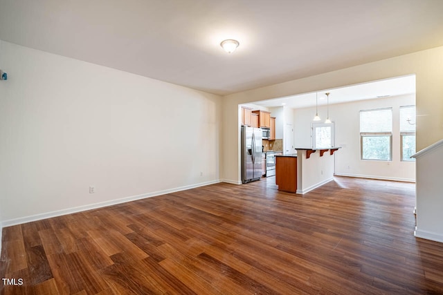 unfurnished living room with dark wood-type flooring