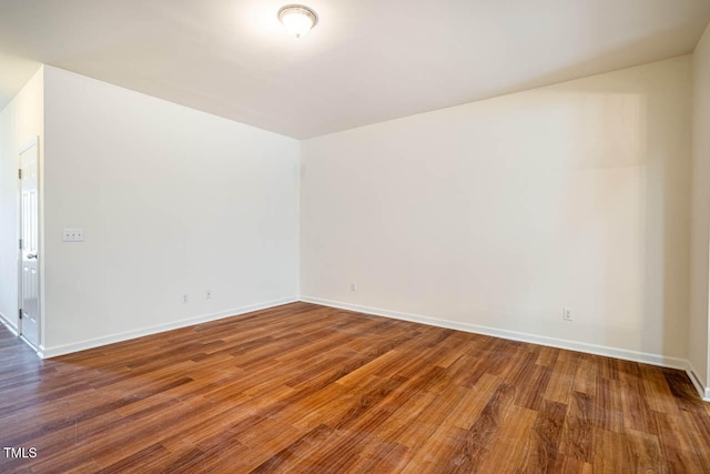 unfurnished room featuring dark hardwood / wood-style floors