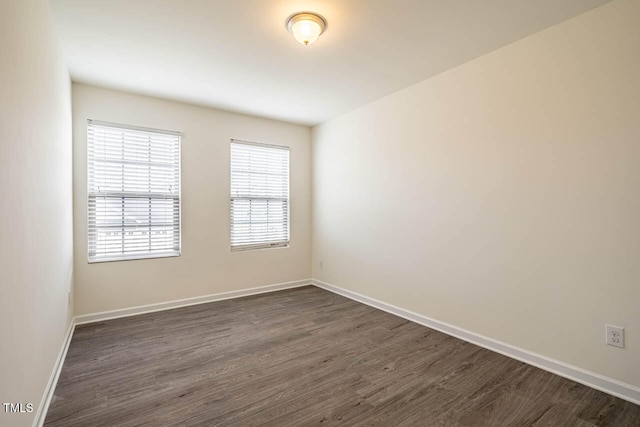 unfurnished room with dark hardwood / wood-style flooring