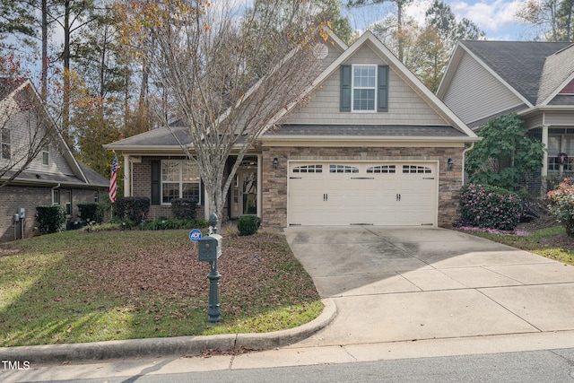 craftsman-style home featuring a front yard and a garage