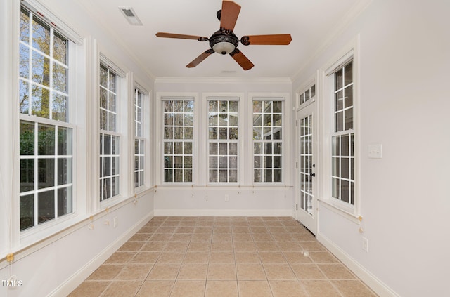 unfurnished sunroom with a wealth of natural light and ceiling fan