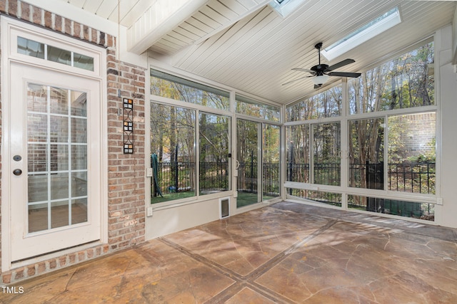 unfurnished sunroom with wood ceiling, lofted ceiling with skylight, plenty of natural light, and ceiling fan