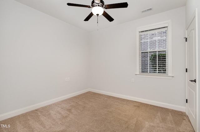 unfurnished room featuring ceiling fan and carpet