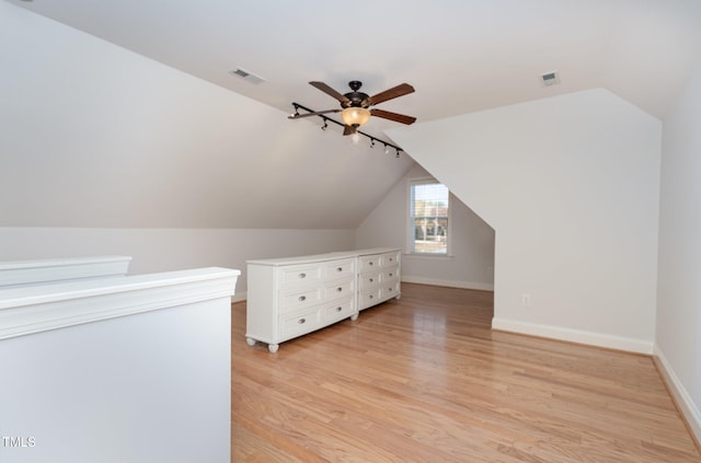 bonus room featuring light hardwood / wood-style floors, vaulted ceiling, and ceiling fan