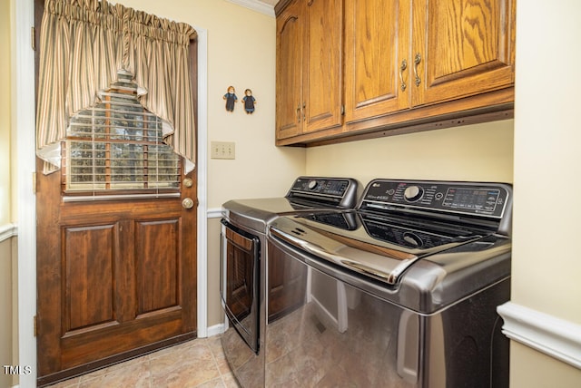 washroom with washer and dryer, ornamental molding, and cabinets