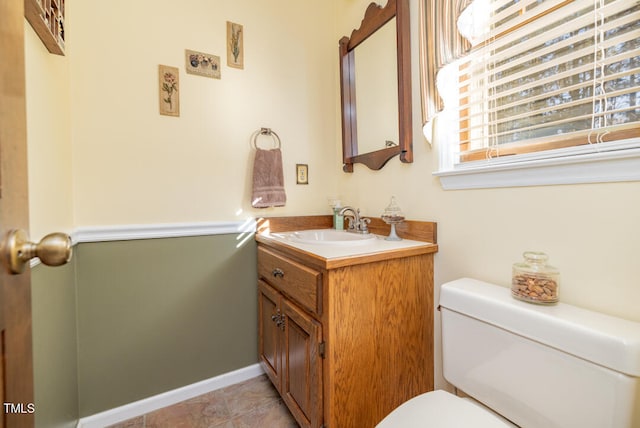 bathroom featuring tile patterned floors, vanity, and toilet