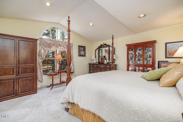 carpeted bedroom with lofted ceiling