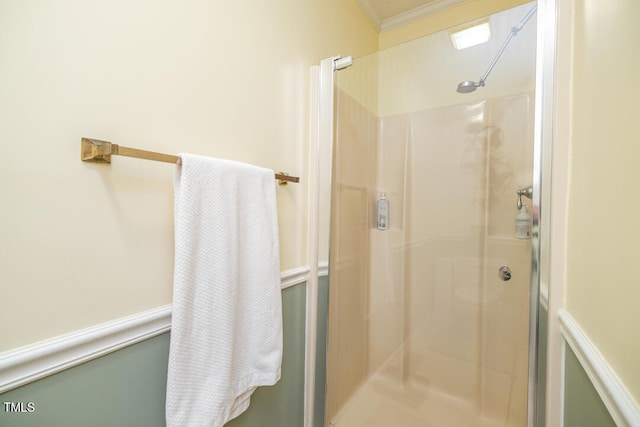 bathroom with walk in shower and ornamental molding