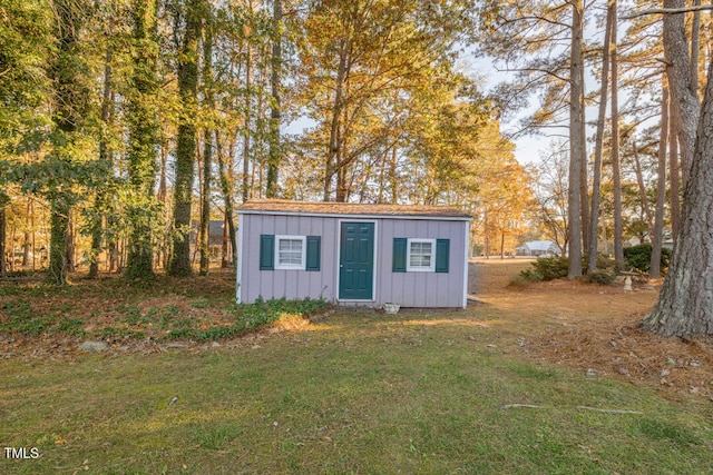 view of outbuilding featuring a lawn