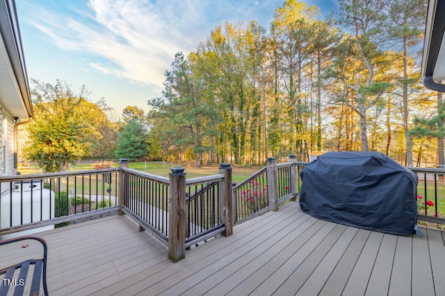 wooden terrace featuring a grill