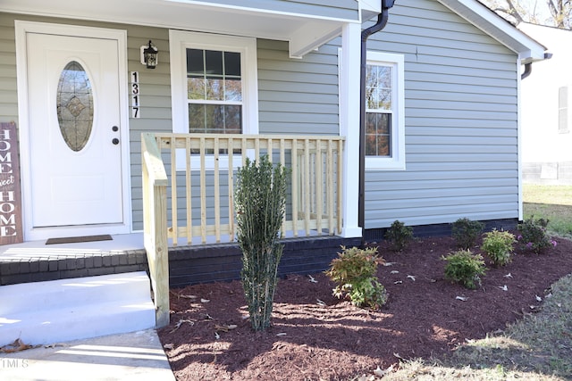 view of exterior entry with a porch