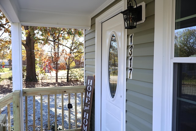 view of exterior entry with a porch