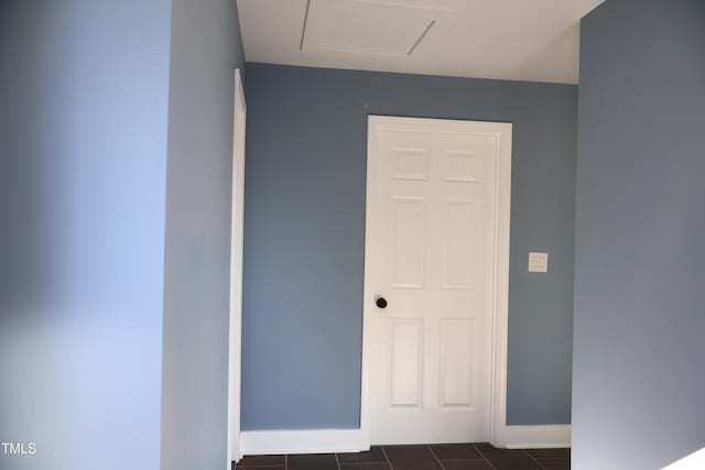 hallway featuring dark tile patterned flooring