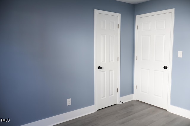 spare room with wood-type flooring