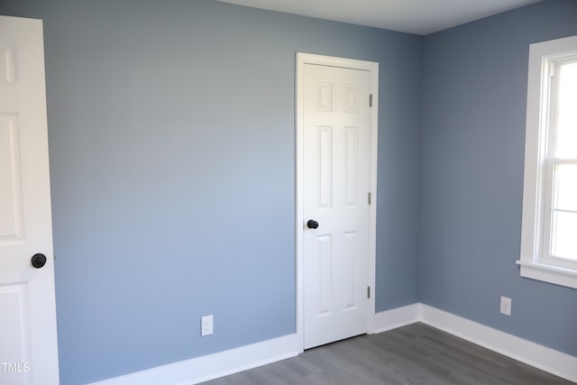 unfurnished room with hardwood / wood-style flooring