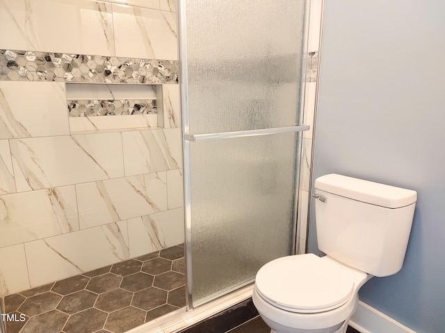 bathroom featuring toilet and walk in shower