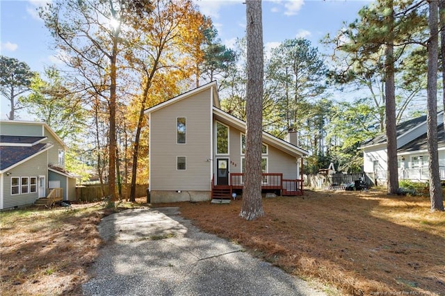 view of side of property with a wooden deck