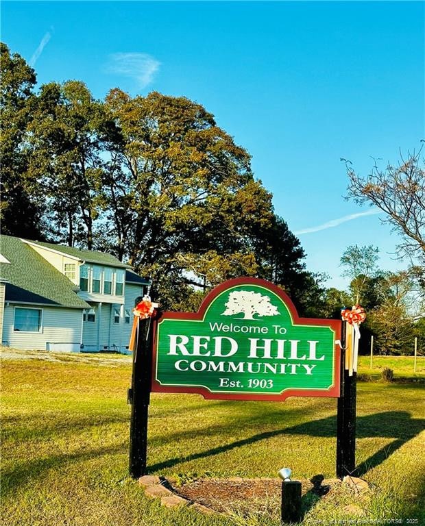 community / neighborhood sign featuring a lawn