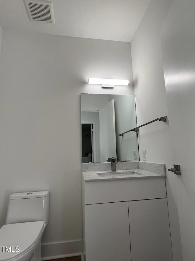 bathroom with vanity and toilet