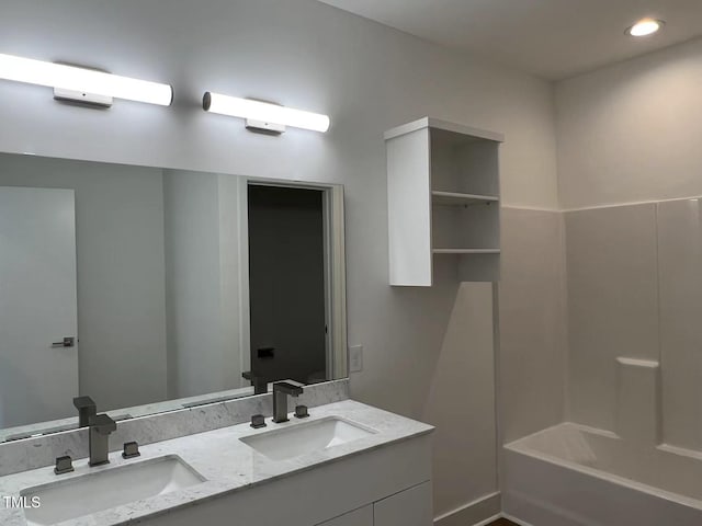 bathroom with washtub / shower combination and vanity