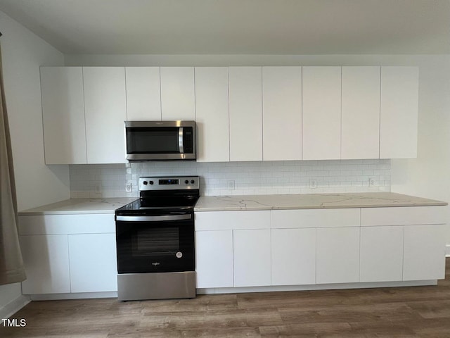 kitchen featuring white cabinets, stainless steel appliances, and light hardwood / wood-style floors