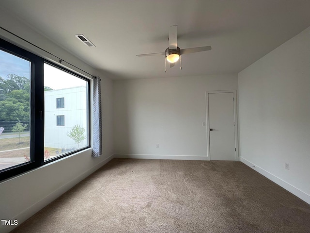 spare room with carpet and ceiling fan