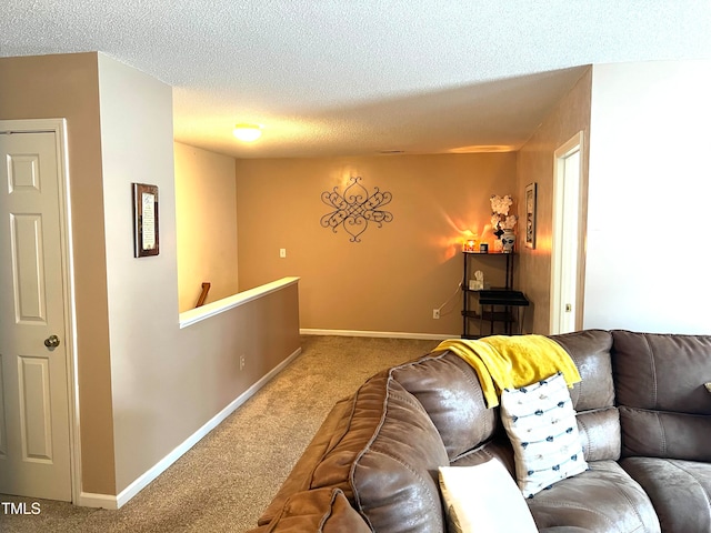 carpeted living room featuring a textured ceiling