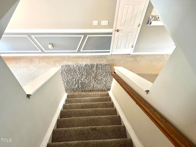 stairs featuring carpet floors