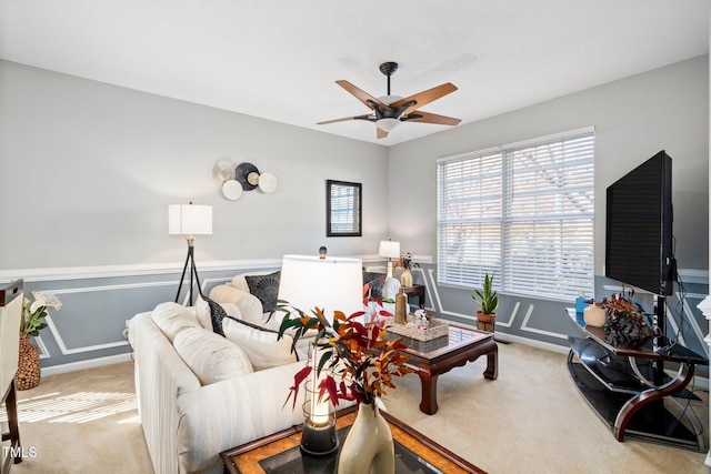 104 Full Moon Ct, Garner, NC 27529 - living room featuring light colored carpet, ceiling fan, and a wainscoted wall