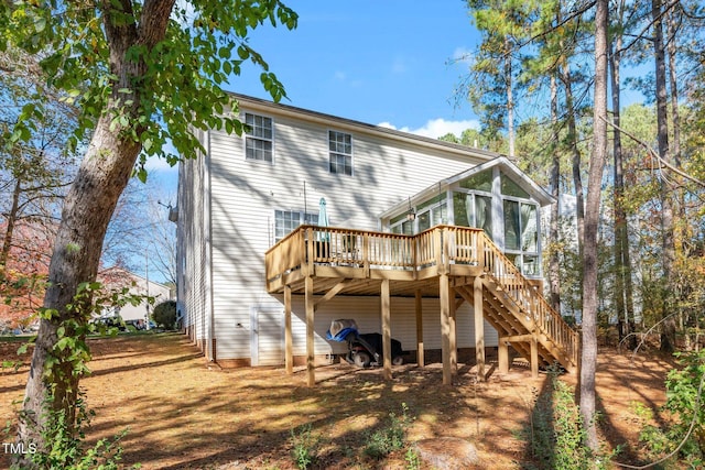 104 Full Moon Ct, Garner, NC 27529 - back of property with a sunroom, stairs, and a deck