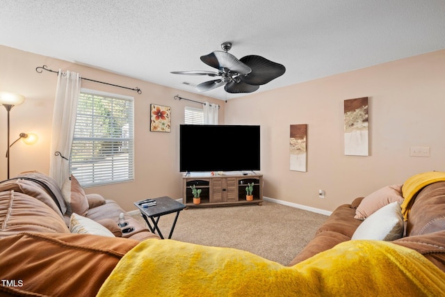 living room with ceiling fan, carpet, and a textured ceiling